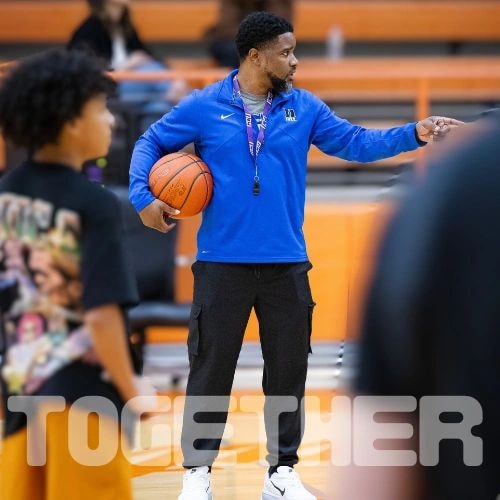 Basketball coach instructing players
